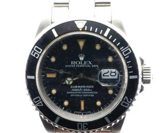 Lot 62:  A 1980's vintage Rolex Submariner Date model gentleman's wristwatch.  Automatic wind movement with a Black Tritium dial, Mercedes hands, Nipple markers, date aperture and sweep seconds, serial #R830240.  40 mm Stainless Steel case and a Rolex "Oyster" Stainless Steel bracelet.  Slight wear, replaced bezel, winds, sets and running when cataloged.  ESTIMATE $3,000-5,000
