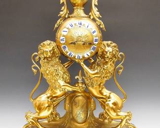 Lot 65:  A late 19th century French Bronze Table clock by Japy Freres, Paris.  8-day time and strike movement with convex engraved Brass dial and porcelain markers with Roman numerals, serial #84838.  Massive Bronze figural case with a Knight's Helmet finial and foliate garlands, on an engraved Brass sphere above two Lions Rampant flanking an engraved Coat of Arms, all on an oval filigreed base.  Minor wear, replaced minute hand, running when cataloged.  30" high overall.  ESTIMATE $3,000-4,000
