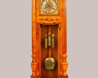 Lot 80: A 19th century Vienna Regulator wall clock.  30-day weight driven movement with quarter hour Grand Sonnerie strike, Silvered dial with Roman numerals, engraved Brass dial center and overlay, matching weights and pendulum.  Oversized Walnut case with carved mask and foliate crest over a single long door with square dial glass and shaped lower flanked by turned columns with fluted detail, shaped lower drop and turned finials.  Older refinishing with restoration to the case, replaced pendulum stick, running when cataloged.  85" high overall.  ESTIMATE $2,000-3,000
