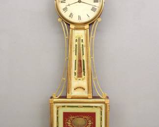 Lot 79: A 19th century American Presentation Banjo clock.  8-day Brass, weight driven time only movement with painted Iron dial and Roman numerals marked "Warranted..".  Gilded Mahogany case with pierced Brass arms, Brass dial door with convex glass over reverse painted throat and lower door glasses, shaped drop with fluted detail.  Re-Gilded with minor wear, restored painted glasses, crack in throat glass, running when cataloged.  40 1/2" high overall.  ESTIMATE $4,000-5,000
