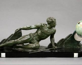 Lot 90: A 1930's Art Deco Period "World Time" figural mantel clock.  Unusual 24 hour Globe form clock with an early electro-mechanical movement with electric winding and flywheel escapement with a mechanical spring driven auxiliary power movement.  The Northern Hemisphere revolves to indicate the hour on a 24 hour scale and the Southern Hemisphere indicates the minutes in five minute intervals, the ring between the two is engraved with the names of countries and regions around the globe.  Figural case with a patinated Spelter figure of a male hunter on a rocky outcrop mounted on a Black Slate base with inset Marble detail.  Minor wear, edge flakes and crack on base, lacks one numeral on hour hemisphere, added 110 transformer for US use, running when cataloged.  44 x 15" high overall.  ESTIMATE $2,000-3,000
