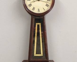 Lot 103:  An early 19th century Horace Tifft type American Banjo clock.  8-day Brass, weight driven time only movement with painted Iron dial with Roman numerals.  Mahogany case with acorn finial and shaped arms, molded dial door with flat circular glass over reverse painted throat and lower door glasses.  Older finish with wear, minor paint loss on glasses, running when cataloged.  32" high overall.  ESTIMATE $1,000-1,500
