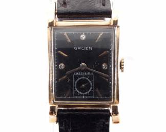Lot 114: A vintage Gruen 14k Gold "Precision" model gentleman's wristwatch.  Manual wind, 17j movement with a Black dial, inset Diamond markers and subsidiary seconds, serial #525679.  21 x 27 mm 14k Yellow gold case with a replaced leather band.  21.0 grams total weight.  Slight wear, winds, sets and running when cataloged.  ESTIMATE $600-800
