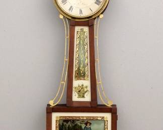 Lot 113: A 19th century American Banjo clock with alarm.  8-day weight driven time only movement with alarm bell on top and painted metal dial and Roman numerals marked " Warranted by, L. W. Noyes".  Mahogany case with pierced Brass arms and Eagle finial, molded Brass dial door over a tapered throat panel and lower door with reverse painted glasses and molded lower drop.  Older refinishing with some wear, replaced finial and lower drop, glasses restored by Tom Moberg, runs momentarily when cataloged.  37" high overall.  ESTIMATE $1,000-2,000
