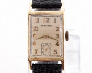 Lot 121: A vintage Hamilton 14k Gold "Brock" model gentleman's wristwatch.  Manual wind, 19j, 982 movement with a Silvered dial, Arabic numerals and subsidiary seconds, serial #M187589.  20 x 27 mm 14k Yellow Gold case with a replaced leather band.  24.8 grams total weight.  Minor wear, winds, sets and running when cataloged.  ESTIMATE $600-800
