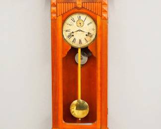 Lot 122:  A late 19th century Gilbert "No. 11" type Regulator wall clock.  8-day spring driven time and strike movement with a papered metal dial, Roman numerals and subsidiary seconds.  Cherry Eastlake Period case with a shaped crest above a paneled frieze with carved detail and a single long molded door with arched glass over a carved bracket drop.  Older refinishing with minor wear, dial wear, running when cataloged.  49 1/4" high overall.  ESTIMATE $800-1,200
