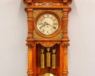 Lot 126: A 19th century German Regulator wall clock.  Lenzkirch 8-day weight driven time and strike movement with quarter hour Grand Sonnerie strike, Silvered dial with Roman numerals, engraved decoration on dial, weights and pendulum, serial #723541 indicates a production date of 1885.  Walnut Transitional case with carved "roof" top and scrolled crest over a molded cornice over a single long door with circular dial glass, applied Brass spandrels and shaped lower flanked by carved pilasters and shaped lower drop with scrolled brackets.  Married movement and case, restored finish with minor wear, running when cataloged.  53 1/2" high overall.  ESTIMATE $800-1,200
