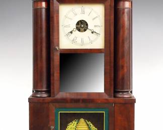 Lot 146: A mid 19th century William Gilbert Double Decker hollow column shelf clock.  30-hr Brass time and strike movement with painted metal dial and Roman numerals.  Mahogany case with a molded cornice, two panel upper door, with clear upper and lower mirror panels flanked by hollow weight columns over a single door base with reverse painted glass.  Paper label 50% intact.  Older finish with minor wear, dial wear, re-painted lower panel, running when cataloged.  28 1/4" high overall.  ESTIMATE $400-600

