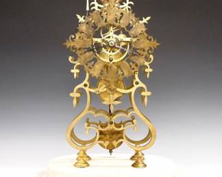 Lot 148: A late 20th century Brass Skeleton clock.&nbsp; 8-day Fusee driven movement with passing strike and Brass cut out dial with Roman numerals.  Shaped Brass plates with turned posts on a stepped White marble base with glass dome.&nbsp; Minor wear, running when cataloged.&nbsp; 19 3/4" high overall.&nbsp; ESTIMATE $400-600
