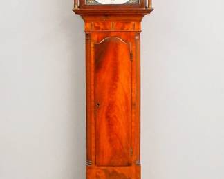 Lot 154: An early 19th century American Tall clock.  8-day time and strike movement with painted Iron dial and Roman numerals, subsidiary date and seconds, marked "Bassett, Warford".  Mahogany case with inlaid detail features a broken arch crest and Brass finials over a shaped dial door flanked by turned columns, over an arched waist door and a paneled base with short turned feet.  Older refinishing with minor wear, some older repair, replaced finials, running when cataloged.  98" high overall.  ESTIMATE $800-1,200
