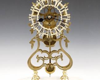 Lot 166: A 20th century English Brass Skeleton clock.&nbsp; 8-day Fusee driven movement with passing strike and Brass cut out dial with Roman numerals.  Shaped Brass plates with turned posts on a stepped White marble base with glass dome.&nbsp; Minor wear, replaced ill-fitting dome, running when cataloged.&nbsp; 19 3/4" high overall.&nbsp; ESTIMATE $600-800
