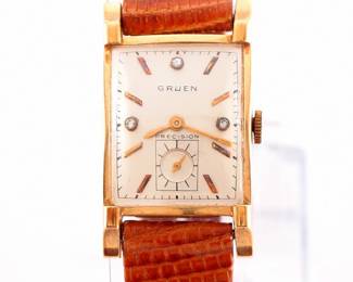 Lot 170:  A vintage Gruen 14k Gold "Precision" model gentleman's wristwatch.  Manual wind, 17j movement with a Black dial, inset Diamond markers and subsidiary seconds, serial #700703.  21 x 27 mm 14k Yellow Gold case with a replaced leather band.  24.9 grams total weight.  Slight wear, winds, sets and running when cataloged.  ESTIMATE $400-600
