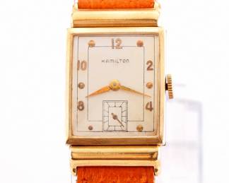 Lot 173: A vintage Hamilton 14k Gold "Barton" model gentleman's wristwatch.  Manual wind, 19j, 982 movement with a Silvered dial, Round markers and subsidiary seconds, serial #M96197.  22 x 36 mm 14k Yellow Gold case with a replaced leather band.  27.8 grams total weight.  Slight wear, winds, sets and running when cataloged.  ESTIMATE $400-600
