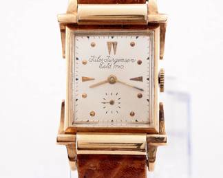 Lot 177:  A vintage Jules Jurgensen 14k Gold gentleman's wristwatch.  Manual wind, 17j movement with a Silvered dial, Round/Arrow and subsidiary seconds, serial #504514.  26 x 34 mm 14k Yellow Gold case with extra fancy lugs and a replaced leather band.  27.4 grams total weight.  Slight wear, winds, sets and running when cataloged.  ESTIMATE $400-600
