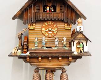 Lot 182: A late 20th century Black Forest Cuckoo wall clock by Anton Schneider & Sohne.  30-hr three train weight driven time and strike movement with music box and automaton, wooden dial with applied Roman numerals.  Chalet form mixed wood case with painted detail and dancing figures.  Original finish with slight wear, running when cataloged.  21" high plus weight drop.  ESTIMATE $600-800

