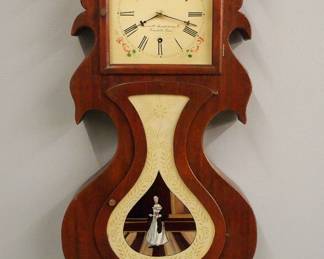 Lot 183: A 20th century replica J. C. Brown style "Acorn" wall clock.  Ansonia 8-day time only movement with a painted metal dial.  Shaped Mahogany case has been hand built using old wood and a modern reverse painted glass, facsimile paper label.  Some wear, running when cataloged.  28" high overall.  ESTIMATE $600-800
