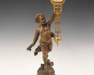 Lot 197: A turn of the century Junghans "Inspiration" model figural swinging arm clock.  30-hr time only movement with porcelain dial and Arabic numerals.  Spelter figure with Medium Brown patina on a Marbleized wooden base.   Some wear, replaced wind and set knobs, hairline in dial, running when cataloged.  16 1/2" high overall.  ESTIMATE $400-600
