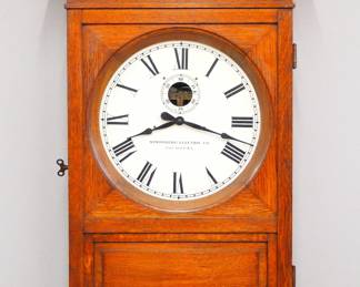 Lot 199: An early 20th century by "Stromberg Electric Co., Chicago U.S.A." Gallery clock.  Electric movement with metal dial and Roman numerals, subsidiary seconds, model #1993-M.  Oak case with molded crown over single paneled door and circular dial glass.  Old finish with minor wear, running when cataloged.  34 1/2" high overall.  ESTIMATE $400-600
