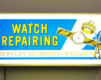 Lot 208: A vintage watch repair sign "Watch Repairing, Jewelry, Diamonds, Watches".  Painted plastic facade with a metal case.  Some wear, working when cataloged.  18 1/4" long x 9 1/4" high overall.  ESTIMATE $200-300
