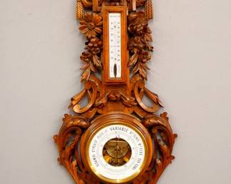 Lot 210: A late 19th century French Barometer by "J. Mahier au Havre".  Upper Centigrade thermometer with porcelain dial and lower Aneroid barometer with circular porcelain dial.  Hand carved Oak case with Lion's mask crest, swags and carved foliate scrolls over a molded lower dial housing and hanging fruit drop.  Older finish with minor wear.  41" high overall.  ESTIMATE $300-500
