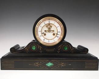 Lot 213: A late 19th century French mantel clock.  8-day time and strike movement with visible escapement and two part porcelain dial with Roman numerals, serial #572.  Black Marble case with Malachite inlay and  inset Gilded detail.  Some wear, minor edge flakes, running when cataloged.  10 1/2" high overall.  ESTIMATE $300-400
