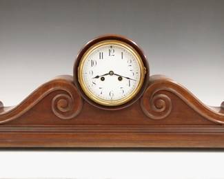 Lot 214:  A 1930's Art Deco Period French mantel clock by Vincenti & Cie, Paris, retailed by H & H (Hamilton & Hamilton) Providence, RI.  8-day time and strike movement with a concave porcelain dial and Arabic numerals.  Oversized Mahogany case with scrolled supports and a molded base with Brass ball feet.  Original finish with some wear, running when cataloged.  27 1/2" long x 10 1/2" high overall.  ESTIMATE $300-400
