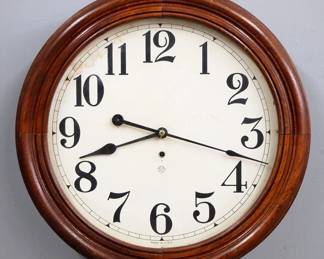 Lot 222:  A late 19th century Ansonia Gallery clock.  8-day time only movement with 18" papered metal dial and Arabic numerals.  Molded Walnut case with lift door.  Paper label verso 60% intact.  Some finish wear, some dial damage, running when cataloged.  23" diameter.  ESTIMATE $400-600
