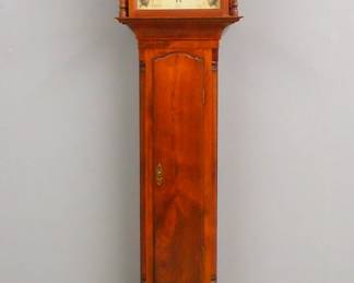 Lot 226:  An early 19th century American Tall clock.  8-day time and strike movement with painted Iron dial and Roman numerals, subsidiary date and seconds.  Later Craftsman made Walnut case with a broken arch crest and turned wooden finials over a shaped dial door flanked by turned columns, over an arched waist door and a paneled base with inset quarter columns and flared feet.  Minor finish wear, re-painted dial, running when cataloged.  98 1/2" high overall.  ESTIMATE $400-600
