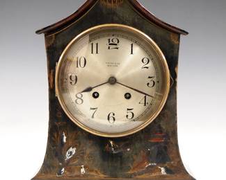 Lot 229:  An early 20th century Chelsea mantel clock made for "Tiffany & Co., New York".  8-day time and strike movement with platform escapement and convex Silvered dial with Arabic numerals.  Cottage form wooden case with Brass dial door and polychrome painted finish.  Wear and some loss to finish, running when cataloged.  12" high overall.  ESTIMATE $300-400
