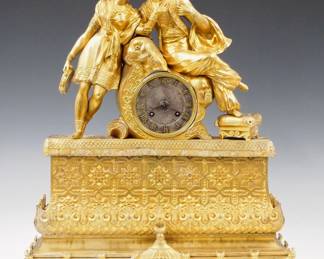 Lot 241:  An early 19th century French Empire Gilded Bronze mantel clock.  8-day time and strike movement with silk thread suspension, Silvered dial with Roman numerals.  Gilded Bronze case with figures of a Middle Eastern man and a dancing girl.  Some surface wear, lacks bell and strike train, dial discoloration, replaced pendulum, lacks several small decorative "tassels",  running momentarily when cataloged.  18" high overall.  ESTIMATE $200-300
