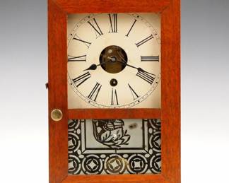 Lot 247: A 19th century S. B. Terry Cottage clock.  30-hr Brass Ladder movement with painted wooden dial and Roman numerals.  Mahogany case with flat top, single door with stenciled lower glass.  Paper label 80% intact.  Refinished, restored dial, running when cataloged.  10 1/4" high overall.  ESTIMATE $200-300
