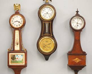 Lot 256: Three 20th century miniature Banjo clocks.  Includes Waltham, Seth Thomas and Gilbert 8-day models, the Gilbert with barometer.  Old finishes with some wear, not tested.  Up to 20 3/4" high.  ESTIMATE $200-300

