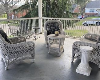 Wicker patio furniture.  Loveseat, two chairs and table.