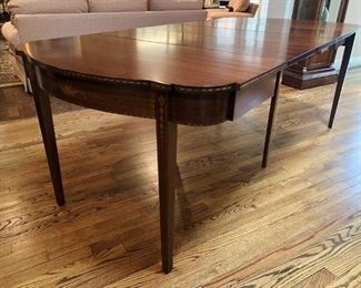 Unusual Henry F. Miller mahogany flip-top table with inlaid marquetry and three leaves to extend to full dining table, early 20th century