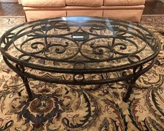 Antiqued finish wrought iron coffee table with beveled glass top