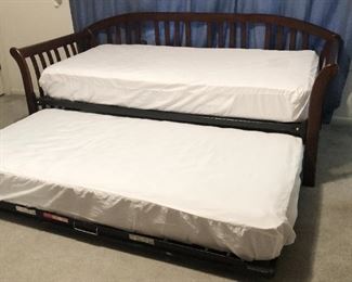 Traditional dark-stained hardwood daybed with trundle