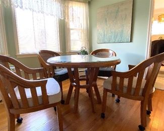 Oak round table (custom glass top) and 4 chairs on casters