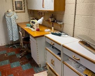 Singer sewing machine with custom sewing table. Wood and white cabinets- there are 5 cabinets to this set- including two tall cabinets