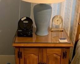 One of two nightstands and blue ceramic lamps