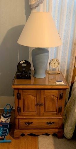 One of two nightstands and blue ceramic lamps