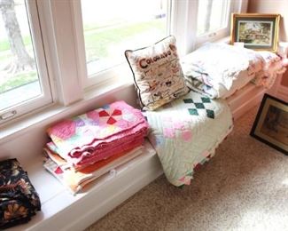 Lots of vintage quilts and linens.  