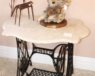 Iron Singer treadle marble top table. $175.00.                     36 1/2" W x  26" D x  28 1/2" H.