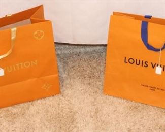 Empty Louis Vuitton shopping bags.