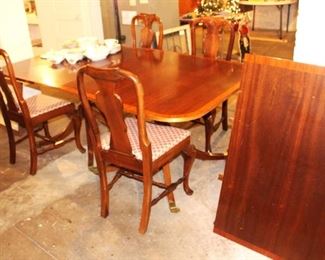 Banded dining table with one large leave.  Four dining chairs.
