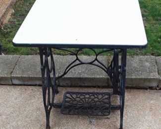 Treadle sewing machine with table top.  