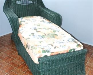 Green wicker lounge with cushion.                                             34 1/2" W x 42" H x 68" L