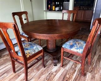 Antique pedestal table with 4 chairs. Comes with 2 leafs.