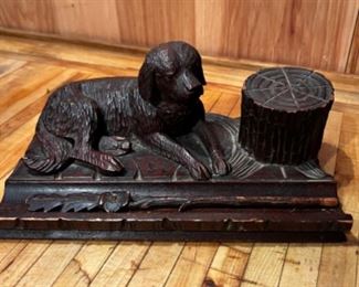 Antique inkwell with boy and dog, with quill.