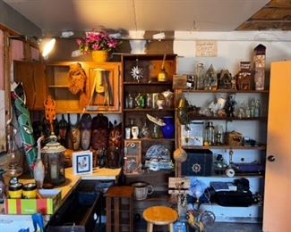 Garage filled with mixed items, tools, many shovels, small tools, 4 small fridges, step ladders, regular ladders, computer armoire, hutch etc