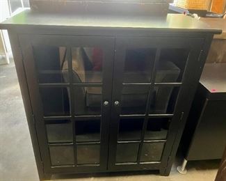 Black bookcase with glass window pane doors